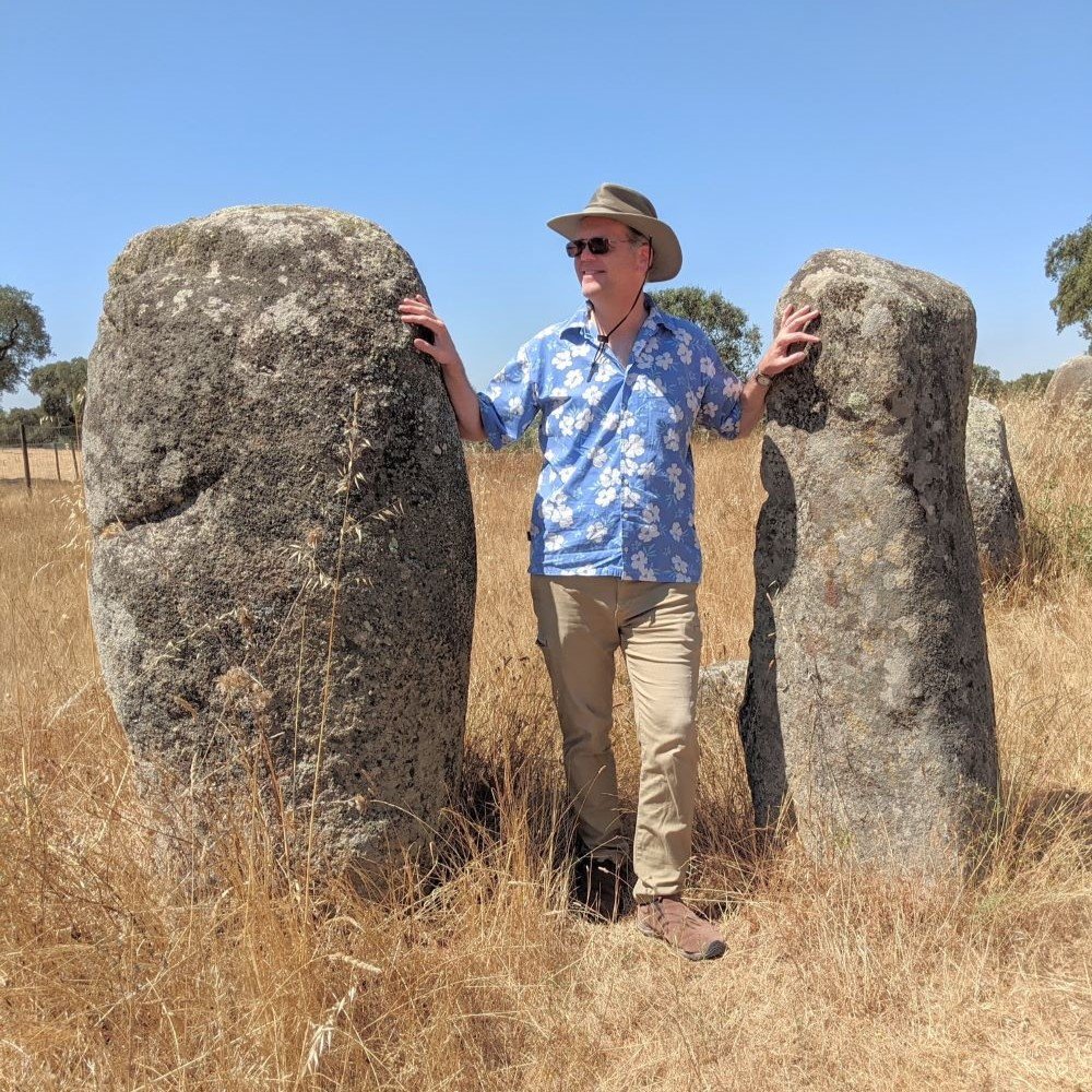 Photograph of the author standing in between two megalithic stones
