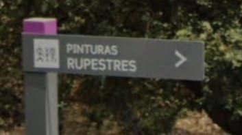 Road sign showing direction to rock paintings