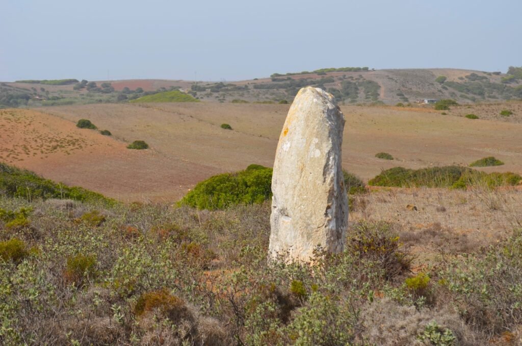 photograph of Menir de Aspradantes standing stone, with view to far hills