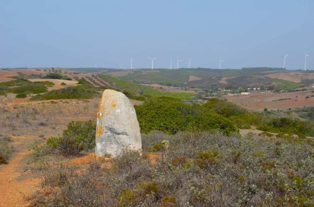 photograph of Menir de Aspradantes standing stone, with view to far hills